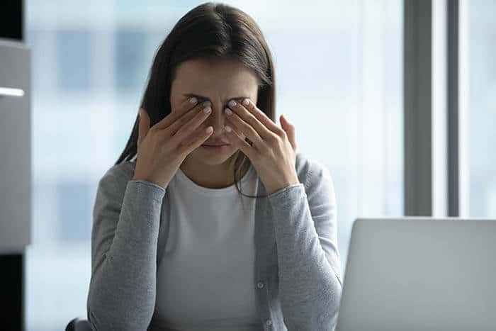 Woman experiencing irritated eyes